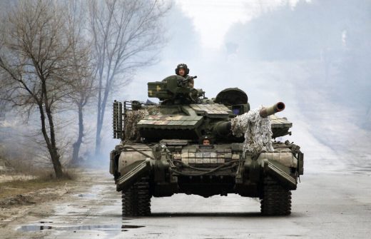 Ukrainian servicemen ride on tanks towards the front line with Russian forces in the Lugansk region of Ukraine on February 25, 2022. - Ukrainian forces fought off Russian troops in the capital Kyiv on the second day of a conflict that has claimed dozens of lives, as the EU approved sanctions targeting President Vladimir Putin.  Small arms fire and explosions were heard in the city's northern district of Obolonsky as what appeared to be an advance party of Russia's invasion force left a trail of destruction. (Photo by Anatolii STEPANOV / AFP) (Photo by ANATOLII STEPANOV/AFP via Getty Images)